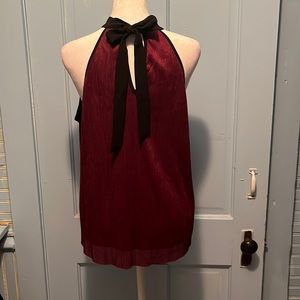 Fancy back tie tank. Shiny ribbed purple material with attached lined tank.